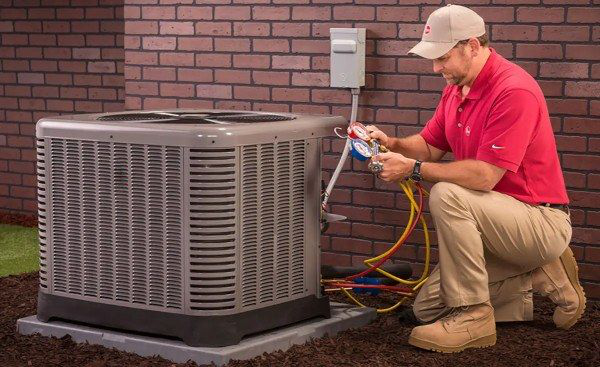 New Life Heating and Cooling - Man servicing AC unit New Life Heating and Cooling - Man servicing AC unit